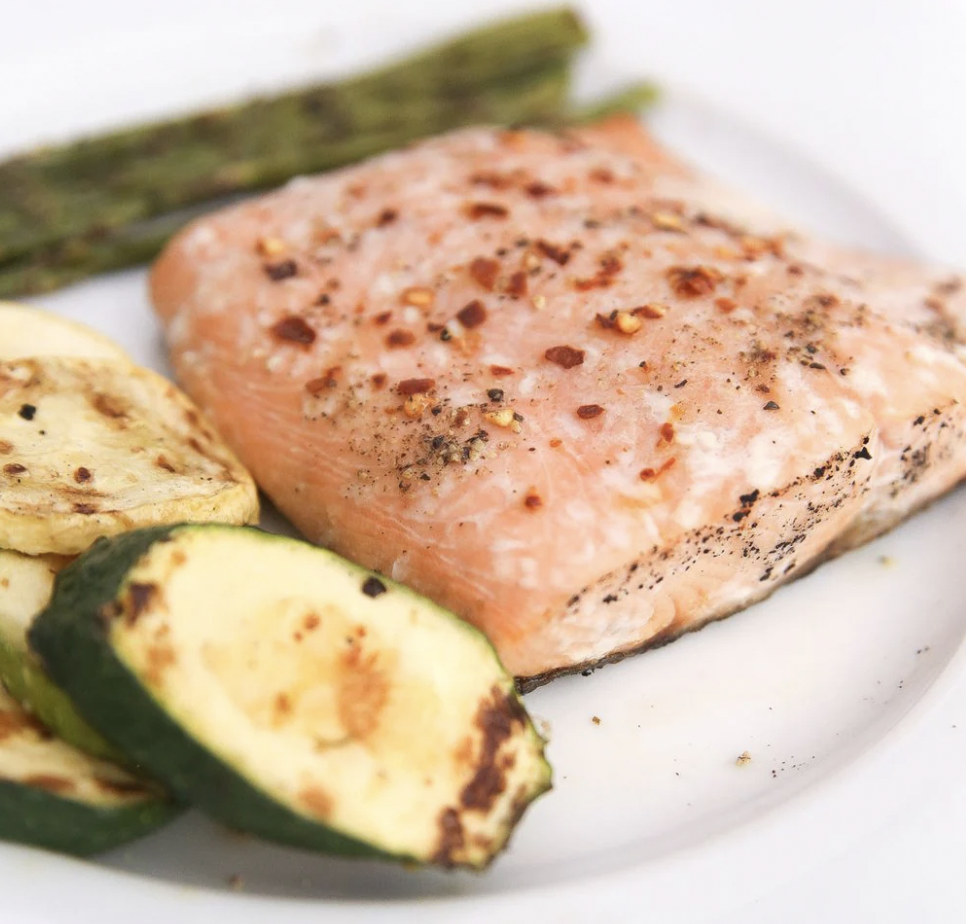 A serving of our wild-caught keta salmon with some veggies on the side