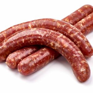 Four pieces of Pork Chorizo Grillers stacked together on white background